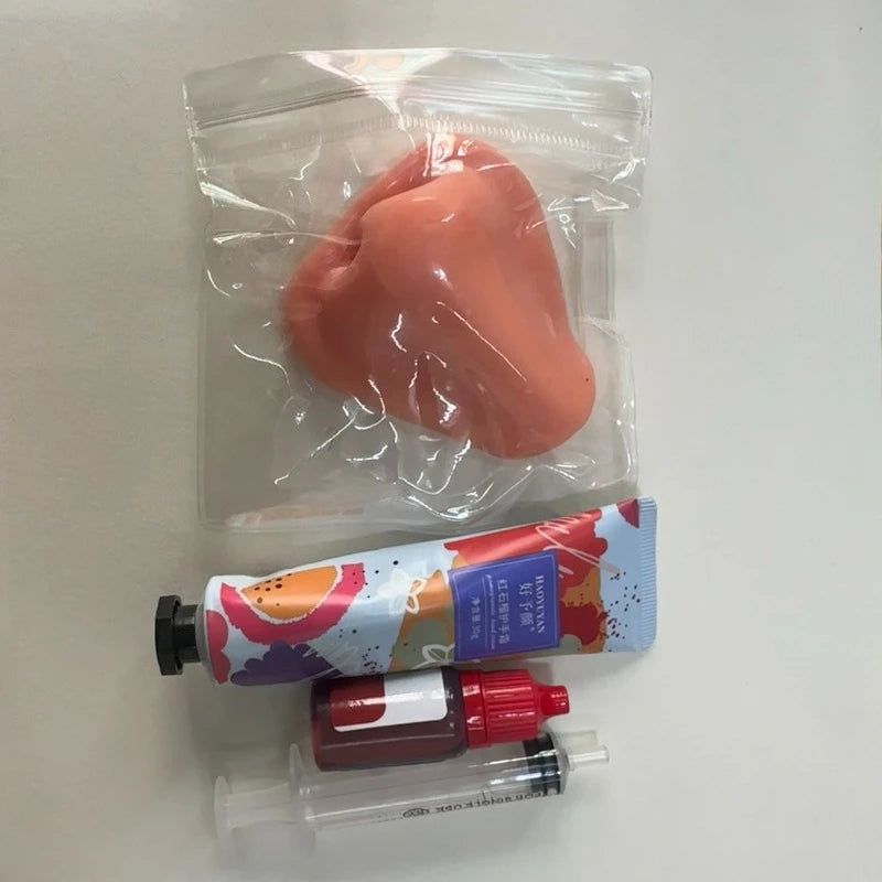 A pink squishy pimple popper fidget toy is shown inside a clear plastic bag next to related tools.