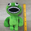 A bright green plush toy resembling a cartoon bird with large eyes and an open mouth.