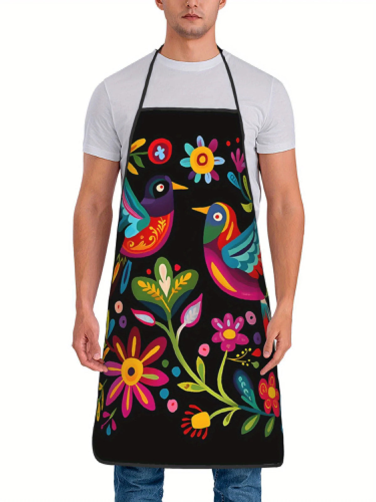 A man wearing a black floral print kitchen apron over a white t-shirt.