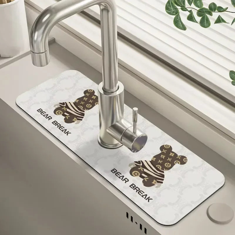 A silver kitchen faucet mounted on a white mat with a bear break design.