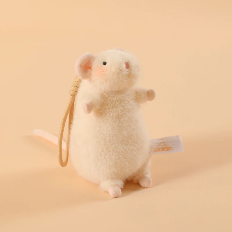A fluffy white plush mouse stuffed animal with a yellow keychain loop.