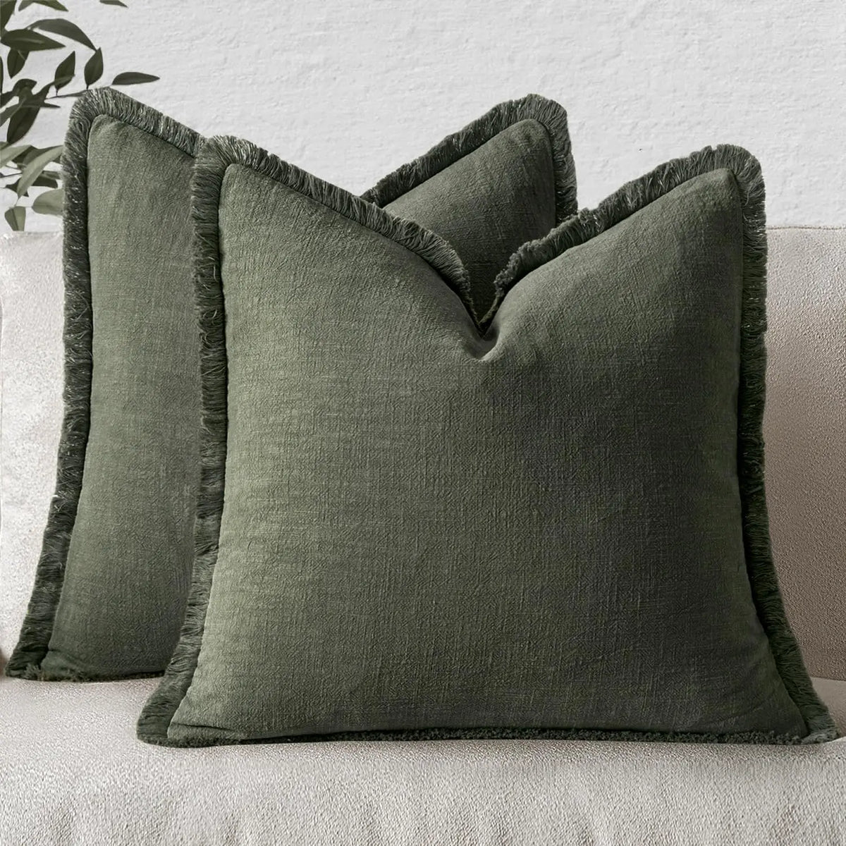 A dark olive green boho fringe throw pillow cover with a natural linen texture.
