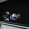 A close-up view of a car camera lens protector showing a blue light effect and a clear lens.
