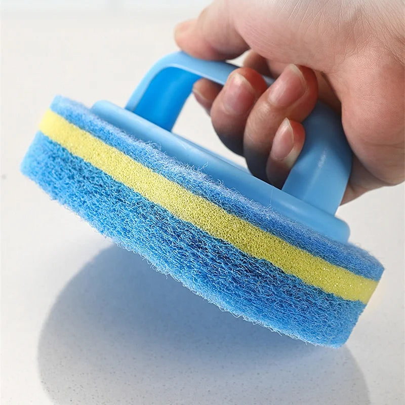 A hand holds a blue and yellow multipurpose sponge cleaning brush with a handle.