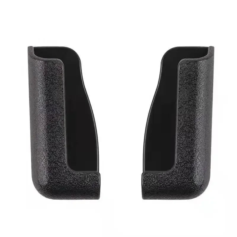 A pair of black crystal air vent car phone holders.