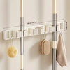 Wall-mounted metal holder for mop and broom with detachable hooks, featuring white and silver finish.