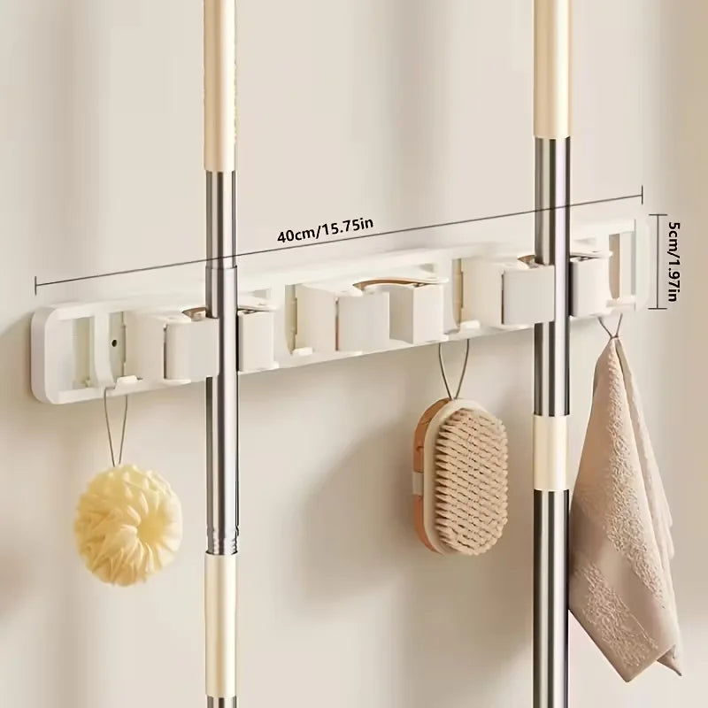 Wall-mounted metal holder for mop and broom with detachable hooks, featuring white and silver finish.