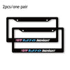 A pair of black racing style license plate frames with Midnight text.