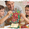 A family is assembling a floral cross building set, featuring red and yellow flowers on a wooden frame.