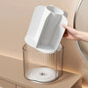 A hand is placing a white makeup brush holder with six compartments into a clear cylindrical container.