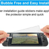 Hands applying a bubble-free screen protector to a Nintendo Switch device.