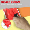 A hand is using a red paint edge trimmer with a rotatable handle to avoid scratching walls.