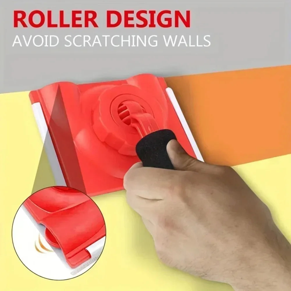 A hand is using a red paint edge trimmer with a rotatable handle to avoid scratching walls.