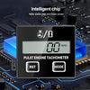 A black digital pulse engine tachometer module with RST and MODE buttons placed on a circuit board.
