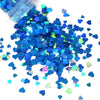 A pile of shiny holographic star sequins in various shades of blue and green for resin crafts.