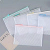 A set of ten clear mesh zipper bags for classroom and craft organization