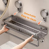 A stainless steel detachable wall-mounted shower caddy with suction cups is shown being installed on a wall.
