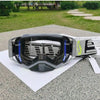 A pair of SCOTT Bauhaus motocross goggles resting on a white paper outdoors.