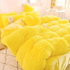 A bright yellow plush mink velvet duvet cover set displayed on a bed.