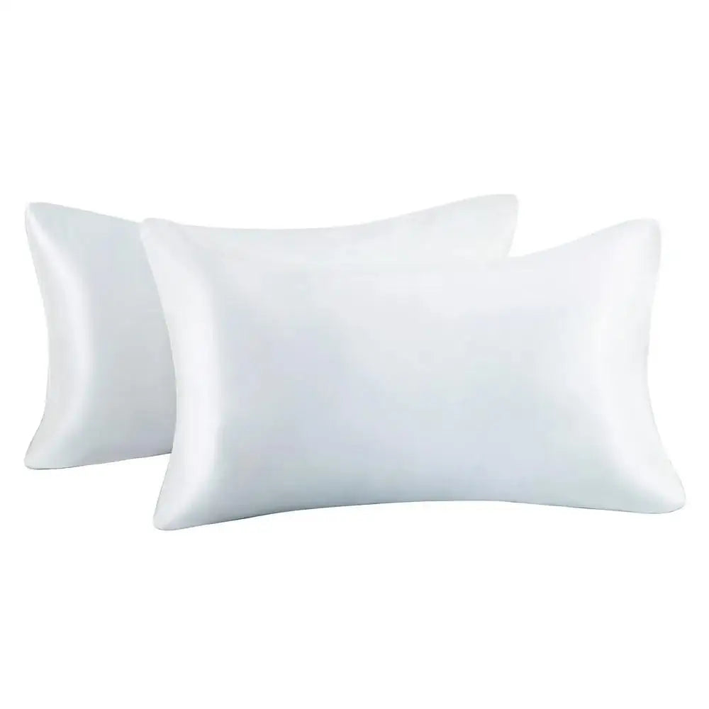 A set of two smooth white silky satin pillowcases for hair and skin.