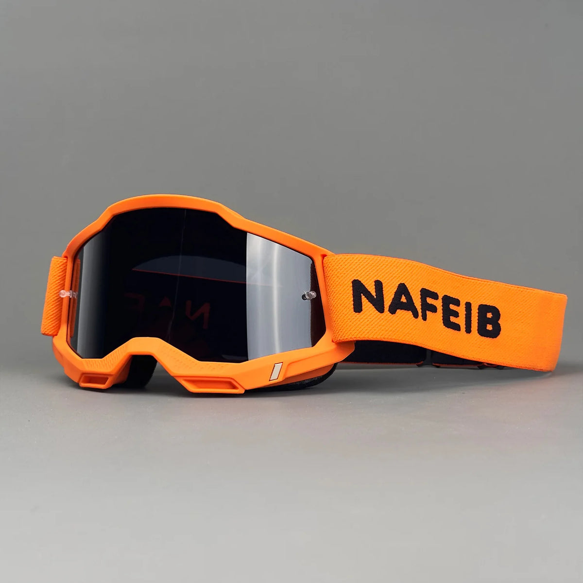 Orange professional MX off-road goggles with a black strap and HD lens