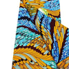 Close-up of a vibrant yellow and blue African wax print fabric featuring intricate feather patterns.