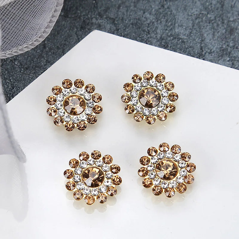A set of five multicolor sew-on flower rhinestones with gold and clear accents displayed on a white surface.