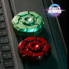 A close-up of a green magnetic fidget spinner and a red magnetic fidget spinner resting on a dark keyboard surface.