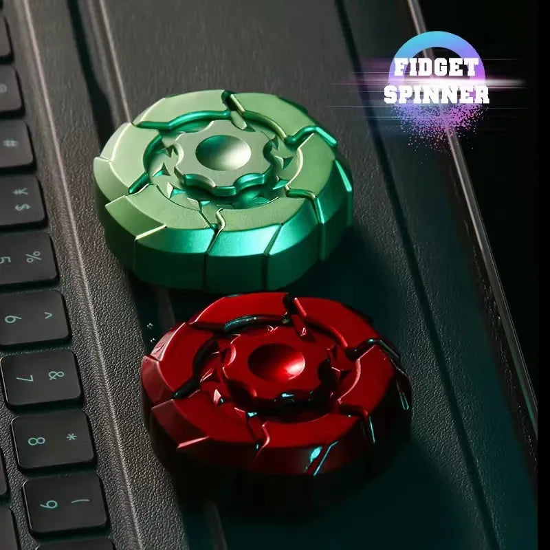 A close-up of a green magnetic fidget spinner and a red magnetic fidget spinner resting on a dark keyboard surface.