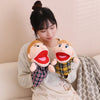 A woman is holding two soft plush hand puppets for kids, featuring rosy cheeks and open mouths.