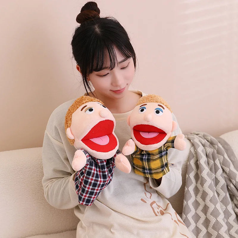 A woman is holding two soft plush hand puppets for kids, featuring rosy cheeks and open mouths.