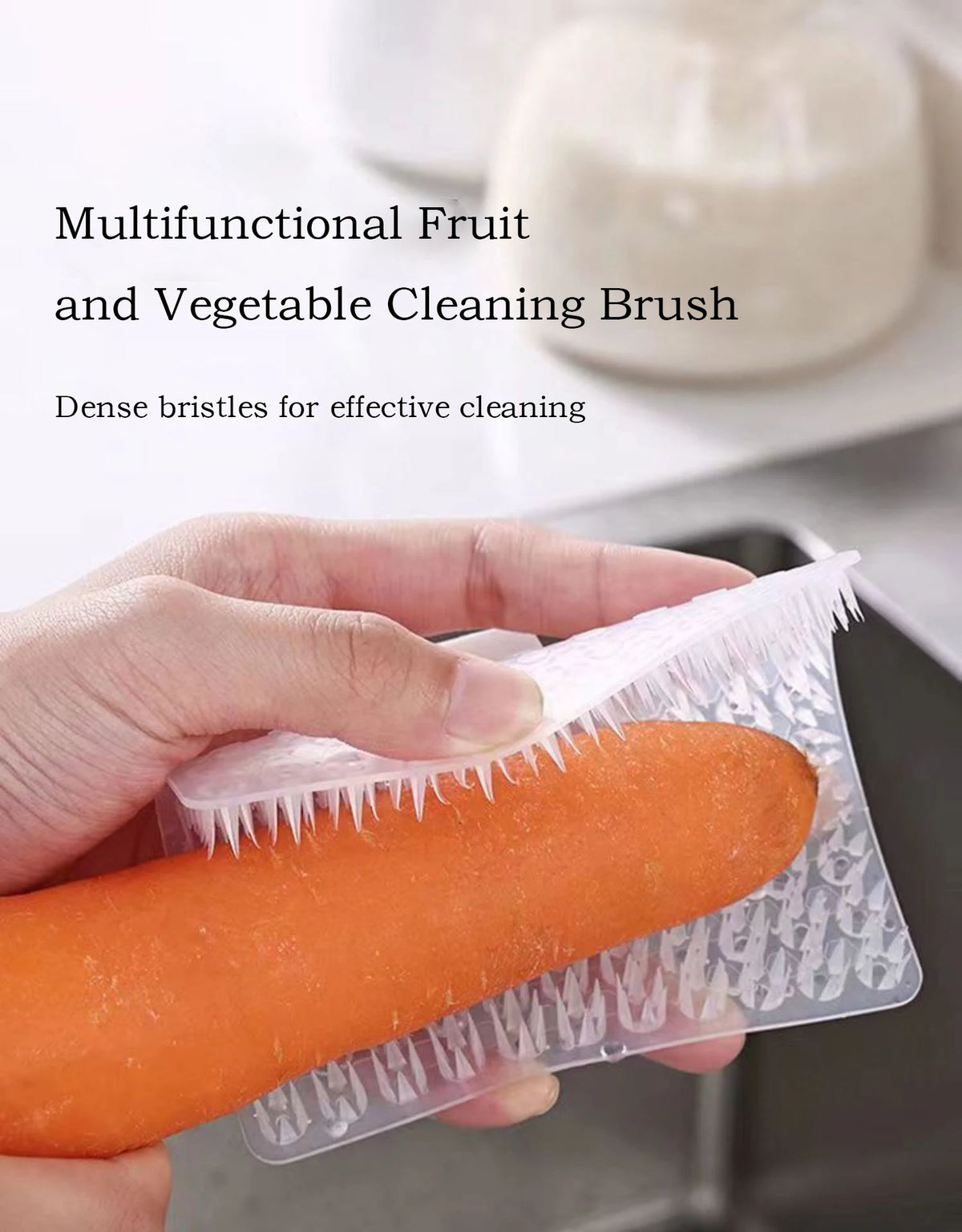 Une main tient une brosse en silicone orange pour nettoyer les fruits et légumes.