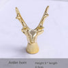 Gold-colored antler horn jewelry holder with a stylized deer head design