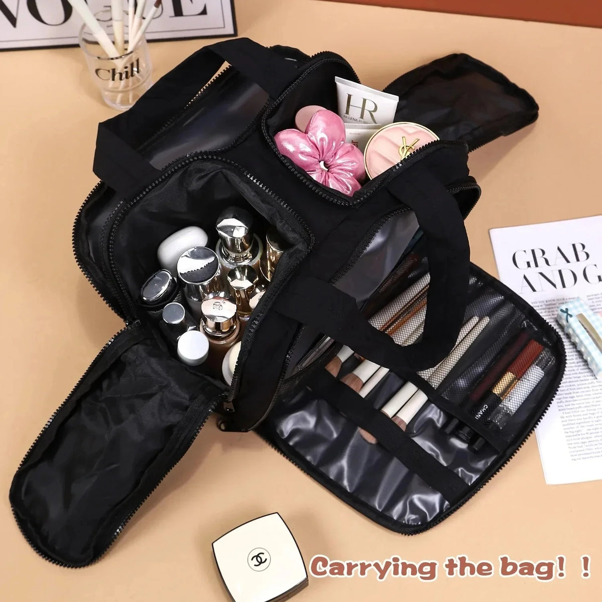 A black travel makeup bag with a wide opening is shown, containing various cosmetic items and brushes.
