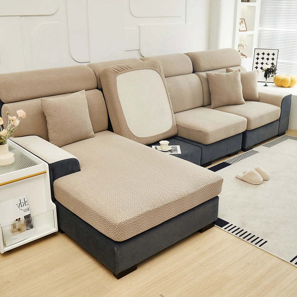 A beige elegant jacquard sofa slipcover with an elastic fit shown in a modern living room setting.
