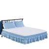 Light blue adjustable elastic bed skirt wrapping around a mattress to hide under-bed space