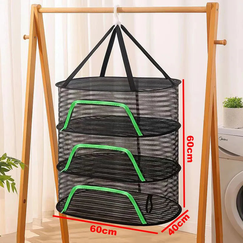 A folding wooden rack holds a black mesh hanging drying net with green accents.