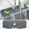 A silicone faucet splash guard is shown spraying water from a kitchen faucet onto a dish rack.