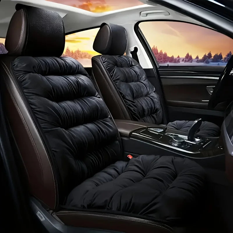 Interior view of a car seat with plush black leather covers and backrests.