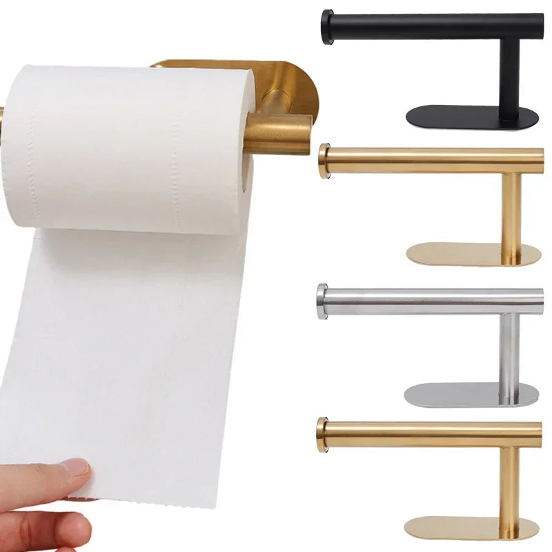 A set of stainless steel and brass toilet paper holders with white paper rolls.