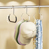 A set of rust-resistant steel round hanger hooks hanging on a bar, with a light-colored hat and a blue patterned scarf visibl