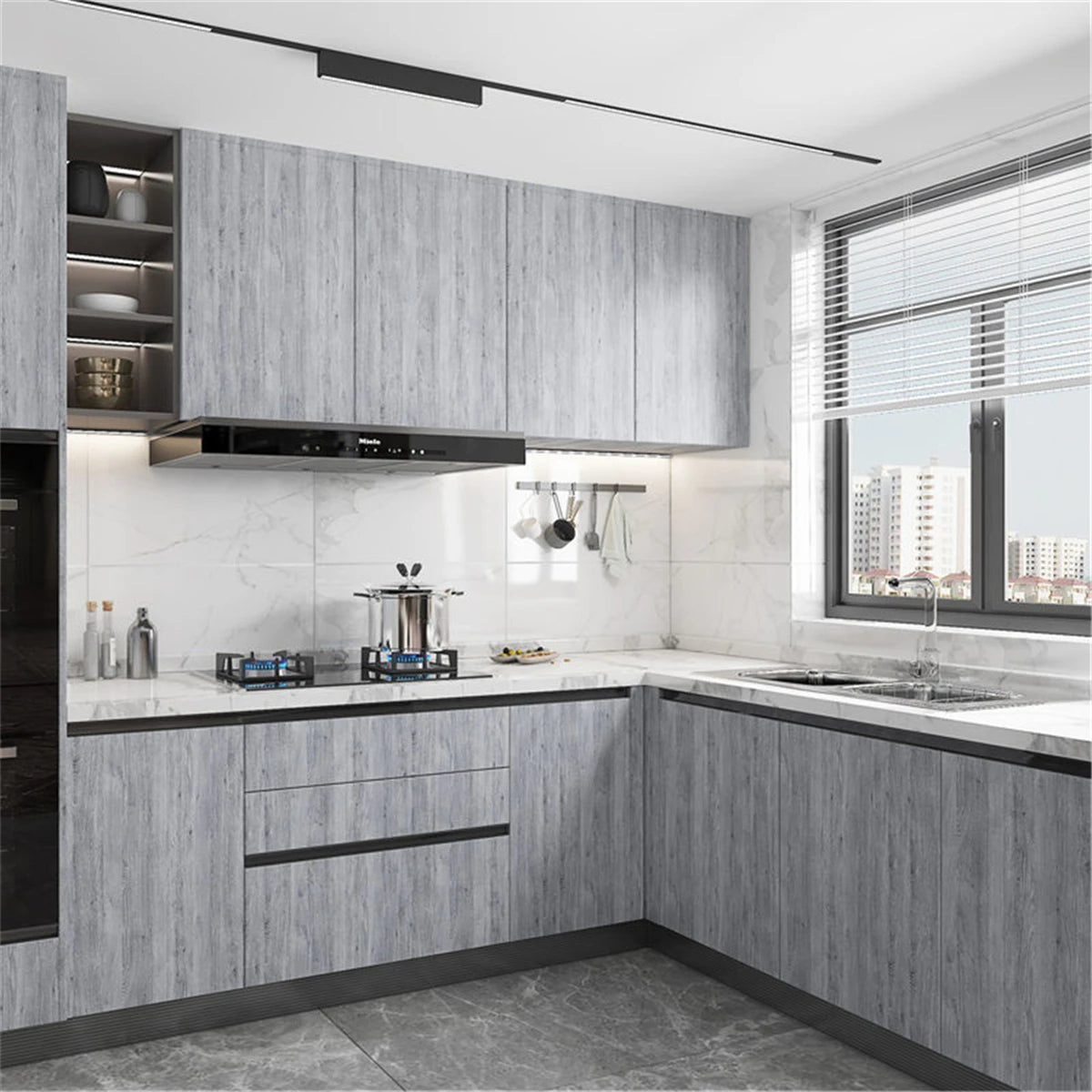 Modern kitchen cabinet installation featuring light gray wood grain vinyl wallpaper and stainless steel appliances.