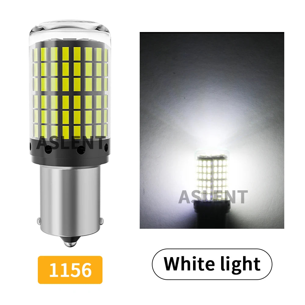 A close-up view of a white LED light bulb with a yellow lens and silver base, showing its bright illumination.