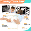 A baby is using a high contrast flash card set to exercise various muscles during tummy time