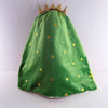 A green plush toy shaped like a Christmas tree with a gold crown and scattered gold stars.