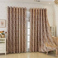 A pair of brown tree bark jacquard blackout curtain panels hanging in a light-colored room.