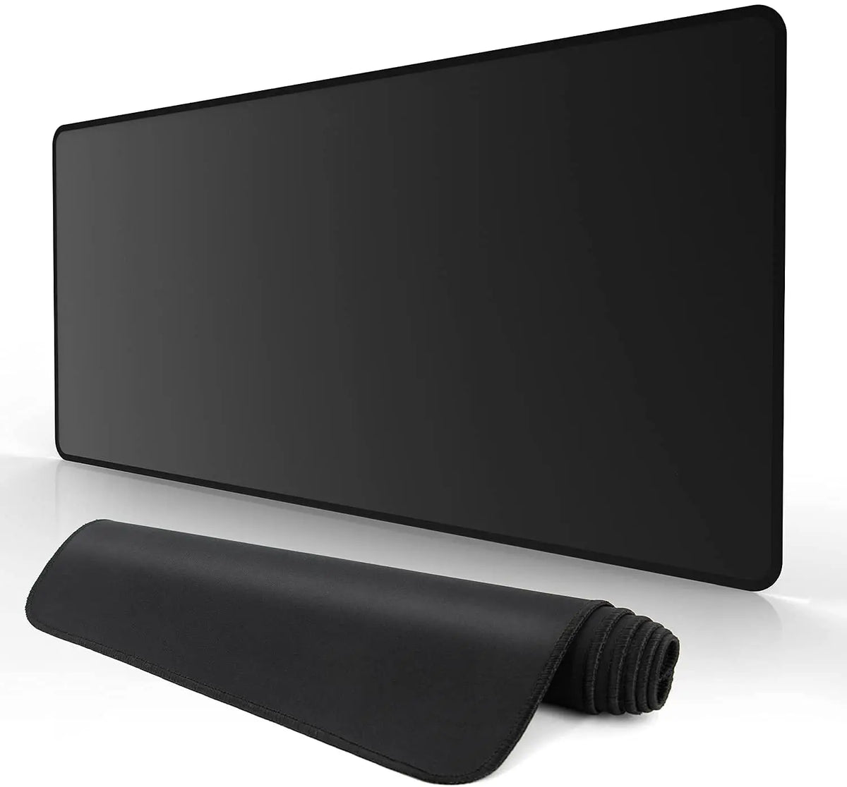 A black extended anti-slip desk pad with stitched edges lying on a white surface.