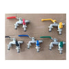 A collection of brass garden water faucets with lever handles in various colors including red, yellow, blue, and green.