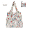 A beige reusable shopping tote bag featuring a pattern of various icons and drawings on a white background.