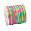 A spool of brightly colored, stretchy rainbow elastic cord for jewelry making.